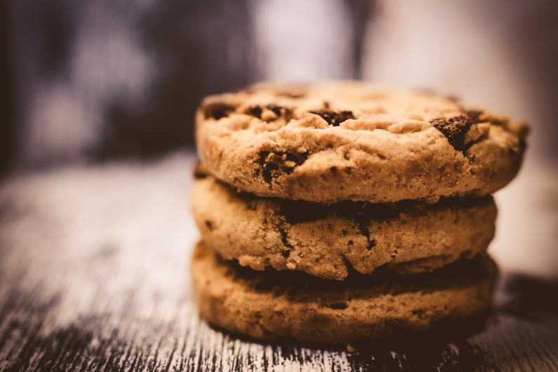A stack of three chocolate chip cookies.